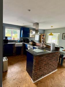 a kitchen with blue cabinets and a brick counter top at An Cnocán in Limerick