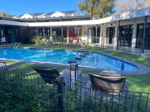 an image of a swimming pool in front of a house at Summer Set West in Somerset West