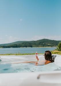 a woman holding a baby in a swimming pool at Aqua Glamp in Jaszczurowa