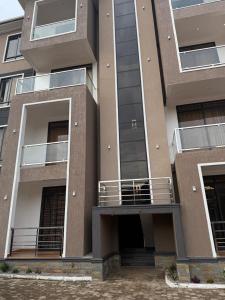 a apartment building with a balcony and a dog on it at Ssentongo Properties Limited in Kampala