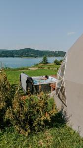 a boat sitting on the grass next to a tent at Aqua Glamp in Jaszczurowa