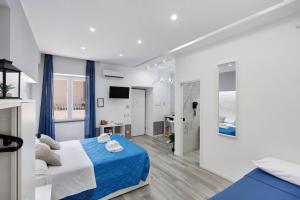 a white bedroom with a blue and white bed at Secretum Pompeii House in Pompei