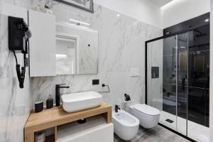 a bathroom with a sink and a toilet and a shower at Secretum Pompeii House in Pompei +20 photos