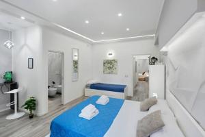 a bedroom with a blue bed and a bathroom at Secretum Pompeii House in Pompei