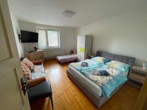a bedroom with a bed and a chair in it at Chalupa u Tomáša in Lúčky