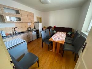 a kitchen and dining room with a table and chairs at Chalupa u Tomáša in Lúčky +13 photos