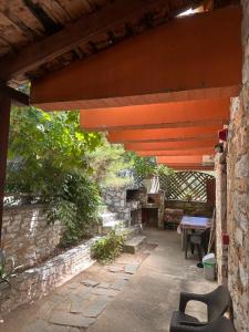 an outdoor patio with a table and a bench at Morfili Villa in Limenaria