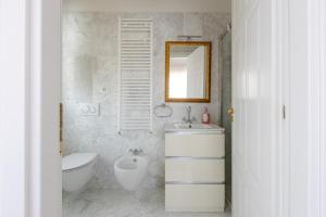a bathroom with a sink and a toilet and a mirror at Casa Bianca in Silvi Marina +38 photos