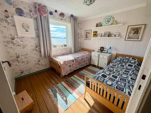 a bedroom with a bed and a window at Fornes Bed & Breakfast in Fornes