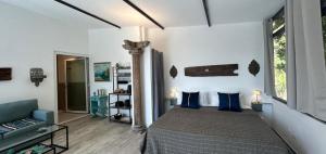 a bedroom with a bed with blue pillows at Naturarte Guesthouse in Terrasini +72 photos