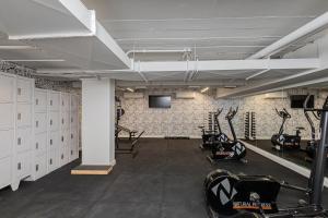 a gym with bikes and a television in a room at One House by Anora Spaces in São Paulo