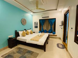 a bedroom with a bed and a blue wall at Hotel Meerana in Jaisalmer +67 photos