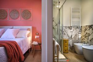 a bedroom with a bed and a bathroom with a tub at Maison Bra 10 in Verona +83 photos