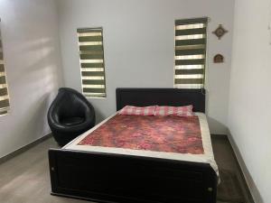 a bed and a chair in a room at SOLITUDE Riverside Holiday Home in Vallikunnu +19 photos