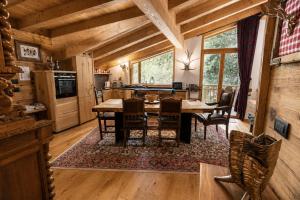 a kitchen and dining room with a table and chairs at Chalet degli Abeti by AMA Val di Fassa in Campitello di Fassa