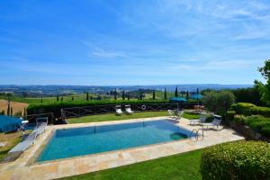 a swimming pool in the yard of a house at Betulla C in San Gimignano