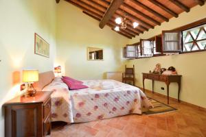 a bedroom with a bed and a table with two dolls on it at Betulla C in San Gimignano