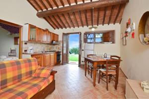 a kitchen and living room with a couch and a table at Betulla C in San Gimignano +31 photos