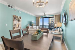a dining room with a table and a living room at Breathtaking Views Emerald Grande 3BR,2BA 904E in Destin