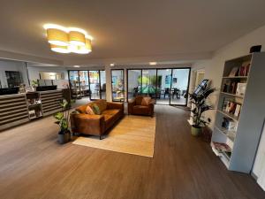 a living room with two chairs and a couch at KNAUS Campingpark Leipzig in Leipzig