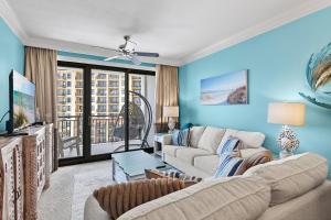 a living room with a couch and a tv at Breathtaking Views Emerald Grande 3BR,2BA 904E in Destin