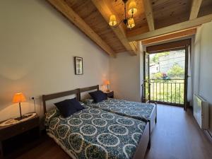 a bedroom with a bed and a large window at Casa Marisa en Cangas de Onís VV-2929-AS in Cangas de Onís