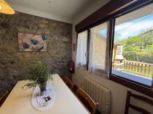 a dining room with a table with a vase on it at Casa Marisa en Cangas de Onís VV-2929-AS in Cangas de Onís +41 photos