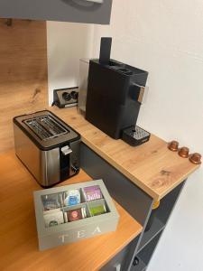 a counter with a coffee maker and a box on it at Alpinchalet Eisenerz in Eisenerz