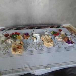 a tray of different types of food on a table at Altyn-Bulak in Kemin