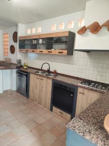 a kitchen with a sink and a stove top oven at Oasi Villa Giusy in Capoterra