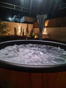 a large hot tub with water in it at night at Oasi Villa Giusy in Capoterra