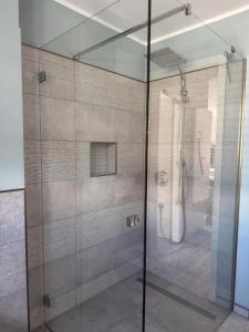 a shower with a glass door in a bathroom at Ferienwohnung Baltic Lounge 53 in Haffkrug
