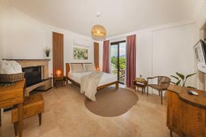 a large bedroom with a bed and a fireplace at Kiraz Vela Selimiye in Marmaris