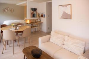 a living room with a white couch and a table at Lalafofofo in Biei