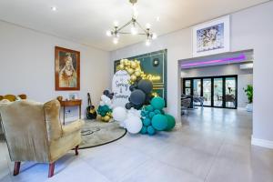 a living room with balloons and a balloon wall at Braham Lodge - The Octave in Johannesburg