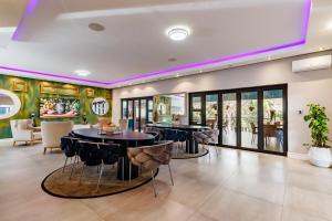 a dining room with tables and chairs in a house at Braham Lodge - The Octave in Johannesburg +64 photos