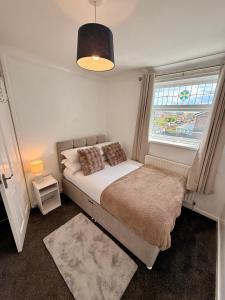 a small bedroom with a bed and a window at Ellington Escape in Ellington