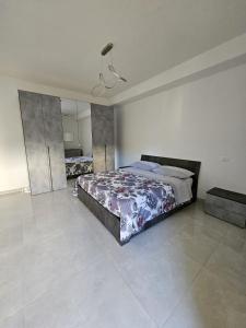 a bedroom with a large bed and a mirror at Sabotino suite in Avezzano