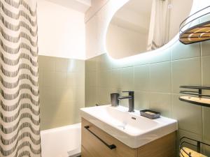 a bathroom with a sink and a mirror at Le Belvedere N11 - ST4 in Saint-Sorlin-dʼArves +5 photos
