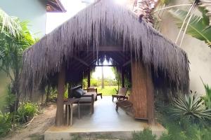 a gazebo with chairs and chairs in a yard at Licuri Praia de Algodões na beira do mar in Marau +11 photos