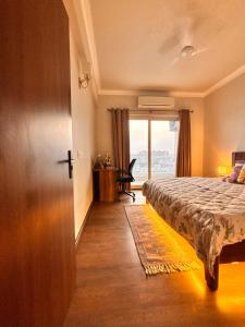 a bedroom with a bed and a door with a window at Romantic Sky Studio with Pool by The Nook in Sohna
