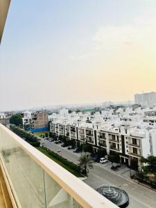 a view of a city from the balcony of a building at Romantic Sky Studio with Pool by The Nook in Sohna +29 photos