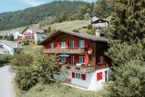 an aerial view of a house with red shutters at Apartment im Chalet Sidonie in Amden