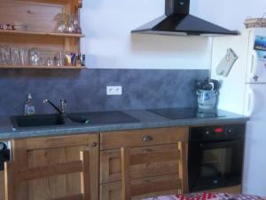 a kitchen with a sink and a stove at Gite Le Chant Du Coq in Bief-des-Maisons +9 photos