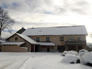 a house covered in snow with snow at Gite Le Chant Du Coq in Bief-des-Maisons