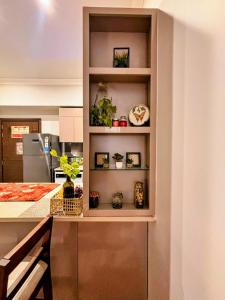 a kitchen with a shelf with plants in it at Romantic Sky Studio with Pool by The Nook in Sohna