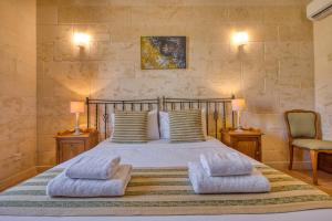 a bedroom with a bed with two pillows on it at Ta' Gianni in Xewkija +32 photos