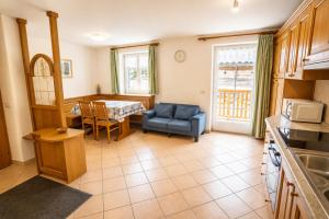a living room with a kitchen and a dining room at Casa Cesarina by AMA Val di Fassa in Canazei