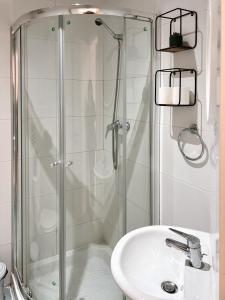 a bathroom with a glass shower and a sink at Malta Crown guesthouse in St. Julianʼs +63 photos