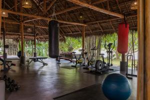 a gym with exercise equipment in a resort at The Namkhan, a Small Luxury Hotel of the World in Luang Prabang